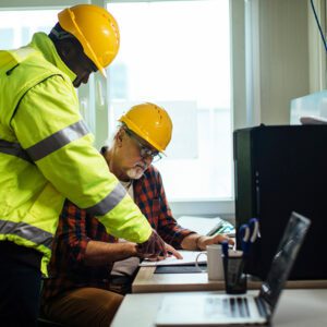 construction workers using a computer